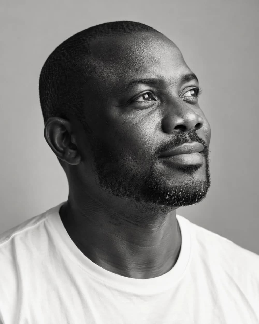 Portrait of a man looking ahead with a calm, hopeful expression