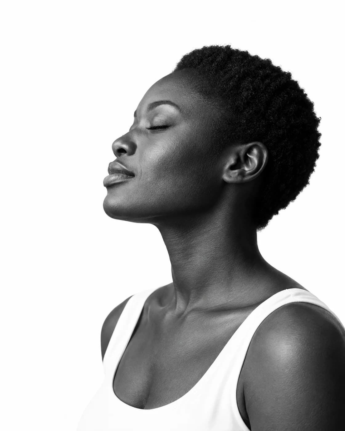 A woman in a quiet moment, her face turned toward the light